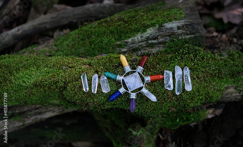 Quartz Pyramid Energy Generator on moss nature background. Crystal Ritual, Witchcraft. Seven Direction Reiki Stone and clear quartz for Energy Healing Meditation photo