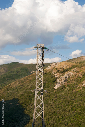 Crests of mount Bulgheria with towers and electrical cables suspended that transmit the electricity to the surrounding mountain towns. Salerno, Italy, Europe. photo