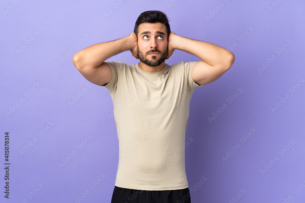 Young handsome man with beard over isolated background frustrated and covering ears Young handsome man with beard over isolated background frustrated and covering ears