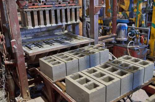 Fotografie Industrial production of building materials from pressed cement mortar