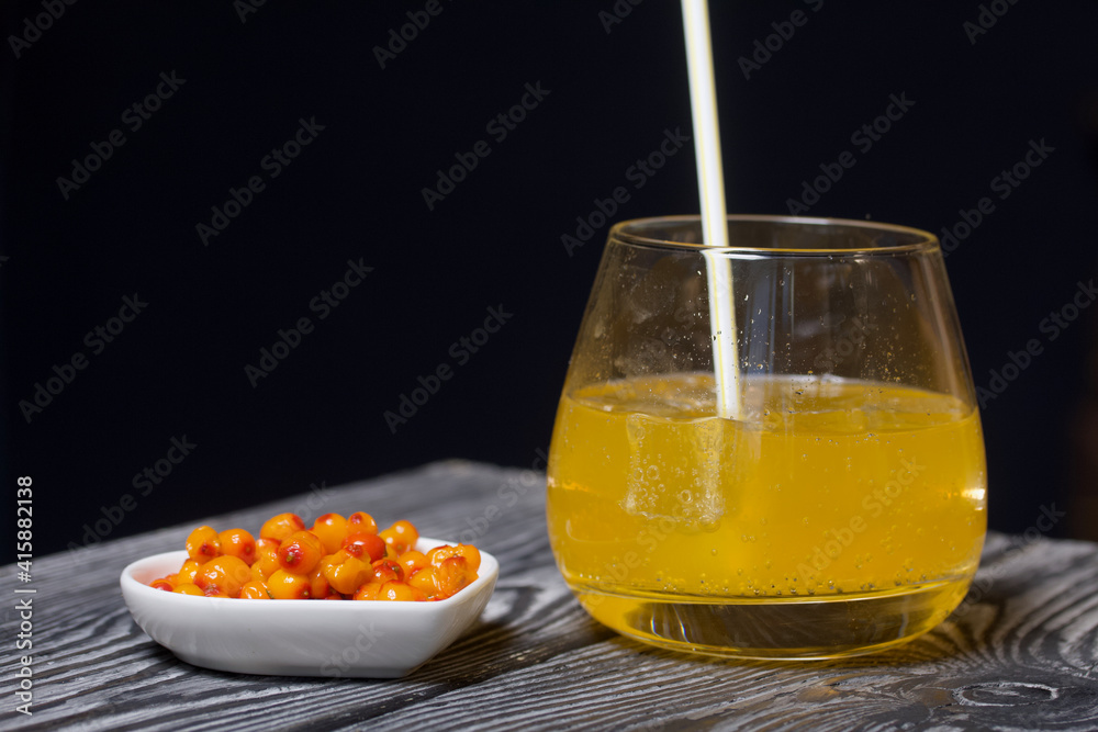 Cocktail with sparkling wine and sea buckthorn. Sea buckthorn bellini with ice.