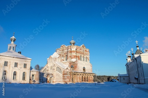 An old church with a bell tower in a male monastery in northern Russia photo