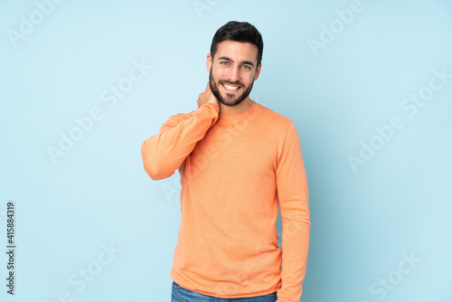 Caucasian handsome man laughing over isolated blue background