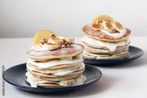 Delicious sweet American pancakes with sour cream apple, banana and walnuts.