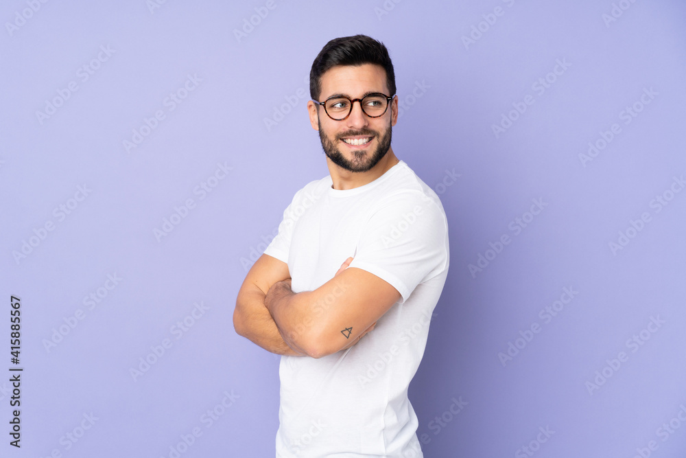 Caucasian handsome man over isolated background looking to the side and smiling