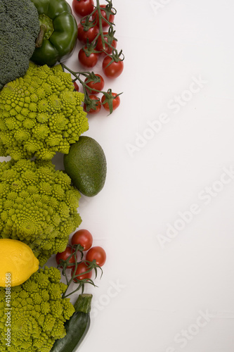 fresh vegetable  romanesco  pepper  zucchini  avocado  cherry tomato and lemon free space in your text  on a isolated background