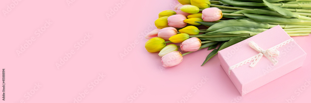 Bouquet of colorful tulips and gift box isolated on pink background. Spring flowers. Greeting card for Birthday, Woman, Mother's Day, Valentine's day. Flat lay. Copy space. Bouquet of colorful tulips and gift box isolated on pink background. Spring flowers. Greeting card for Birthday, Woman, Mother's Day, Valentine's day. Flat lay. Copy space.