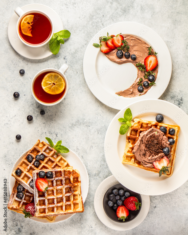 Waffles with chocolate cream and berries flat lay. Home cooking Waffles with chocolate cream and berries flat lay. Home cooking