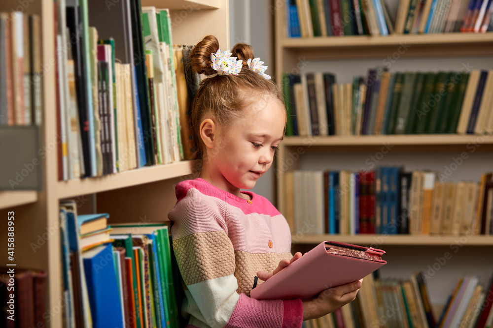 preschool girl reading book in library with patience, caucasian kid girl is concentrated on education, getting knowledge. child s brain development, learn to read, cognitive skills concept preschool girl reading book in library with patience, caucasian kid girl is concentrated on education, getting knowledge. child s brain development, learn to read, cognitive skills concept