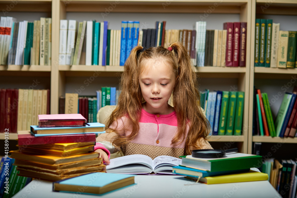 preschool girl reading book in library with patience, caucasian kid girl is concentrated on education, getting knowledge. child s brain development, learn to read, cognitive skills concept preschool girl reading book in library with patience, caucasian kid girl is concentrated on education, getting knowledge. child s brain development, learn to read, cognitive skills concept