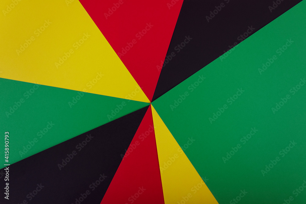 Red, yellow and green colors papers on the black background. Black History Month concept. Flat lay. Copy space. 