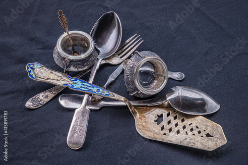 Obraz na płótnie vintage silver utensils on a black surface close up