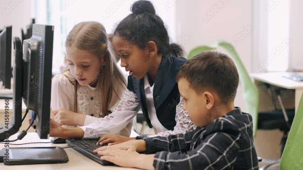 Technologies and studying concept. Schoolchildren working with computer on IT classes at school. Technologies and studying concept. Schoolchildren working with computer on IT classes at school.