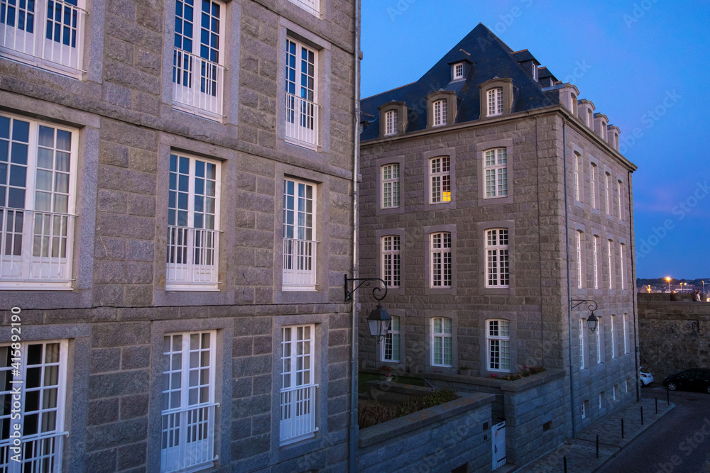 View at sunset from the wall of the old city with granite buildings of Saint-Malo in Brittany, France View at sunset from the wall of the old city with granite buildings of Saint-Malo in Brittany, France