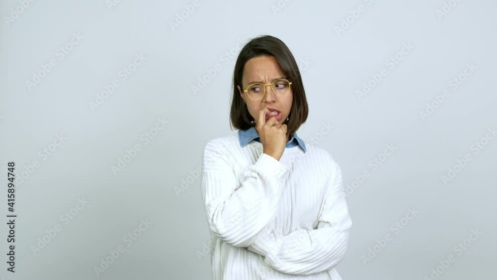 Young brunette woman with glasses having doubts over isolated background Young brunette woman with glasses having doubts over isolated background