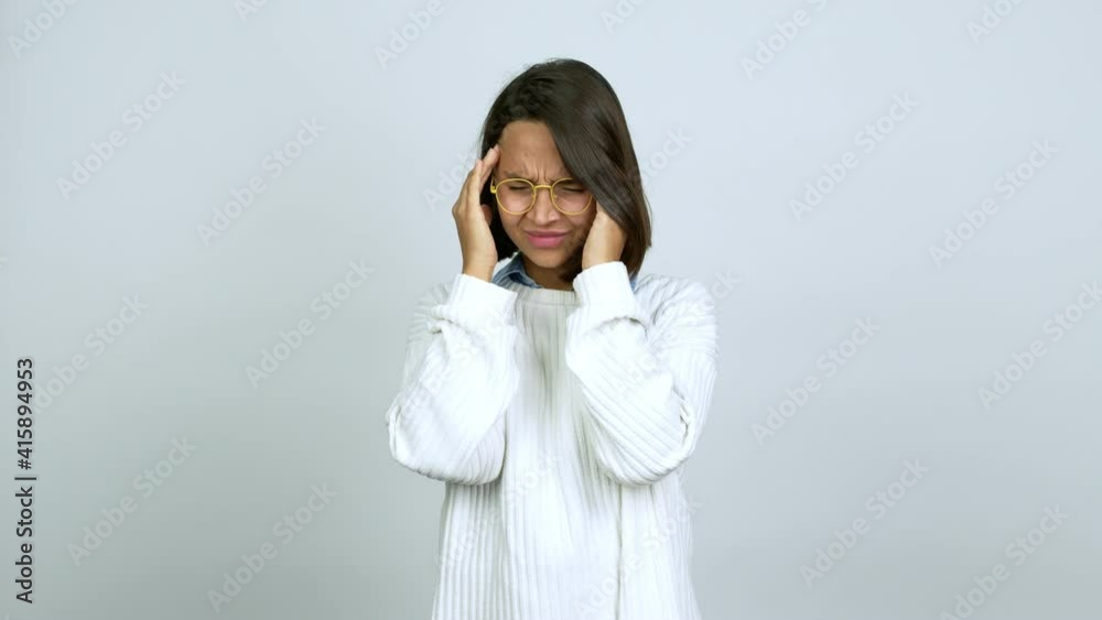 Young brunette woman with glasses with headache over isolated background Young brunette woman with glasses with headache over isolated background