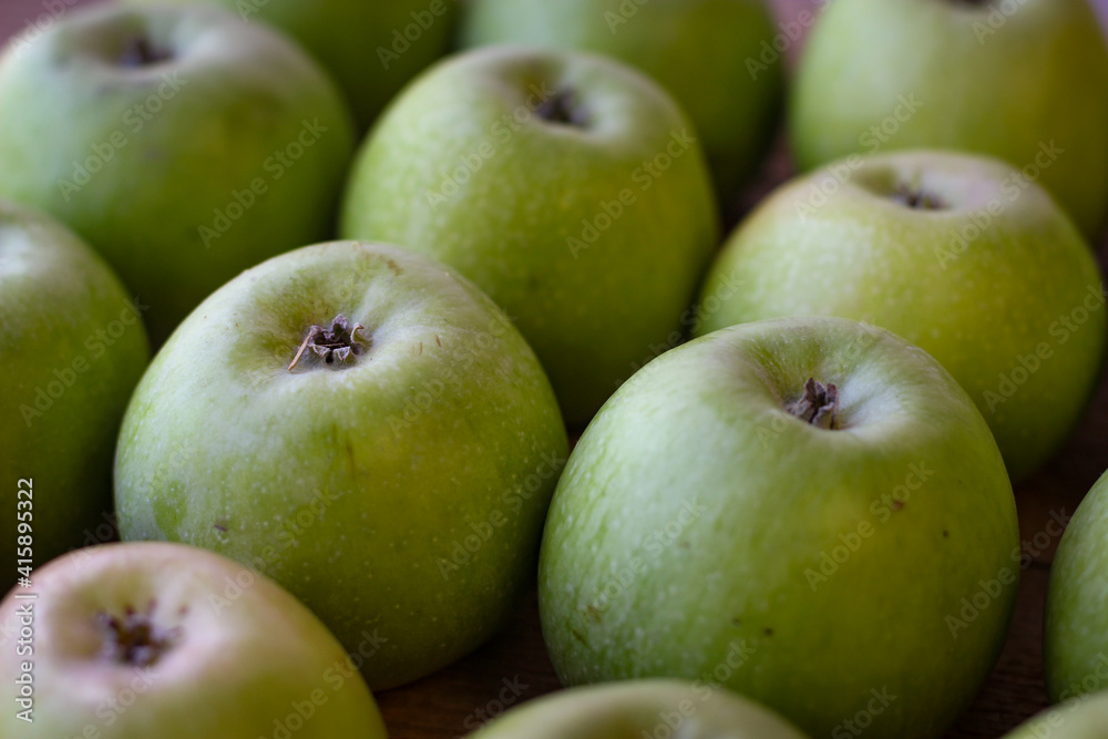 Apples stand on a wooden surface Apples stand on a wooden surface