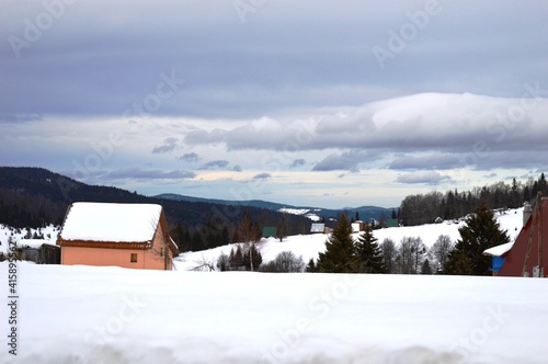 house in a mountain village in winter on snow © oljasimovic
