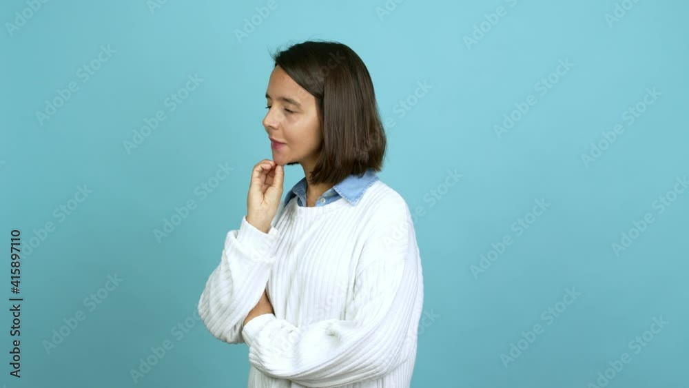 Young brunette woman having doubts and questioning an idea over isolated background Young brunette woman having doubts and questioning an idea over isolated background
