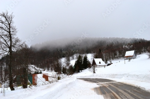 road to a mountain village in winter on snow
