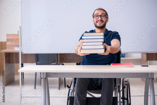 Young male handicapped student in the classroom