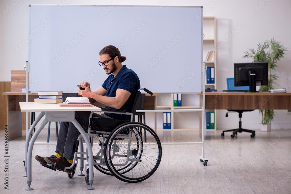 Young male handicapped student in the classroom Young male handicapped student in the classroom