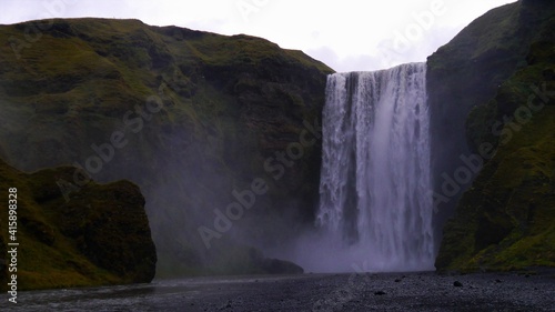 a waterfall with a mountain in the background