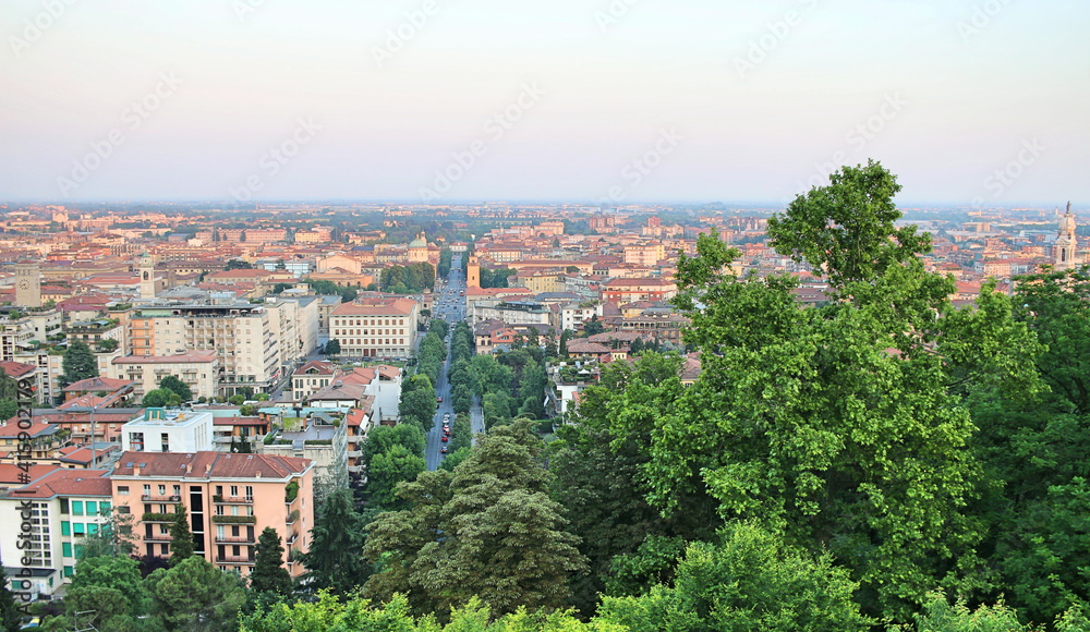 Panorama of Bergamo (Italy). Buildings with red tiled roofs and main road.