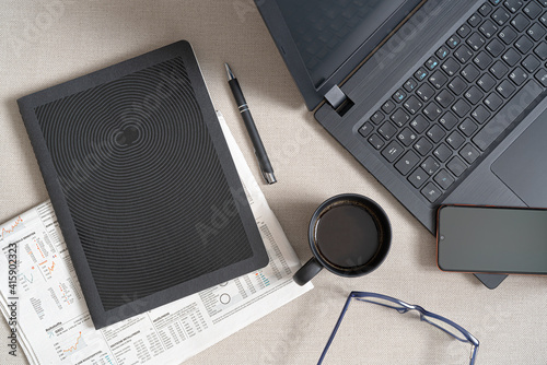 laptop  and pad on desk with cup of coffee