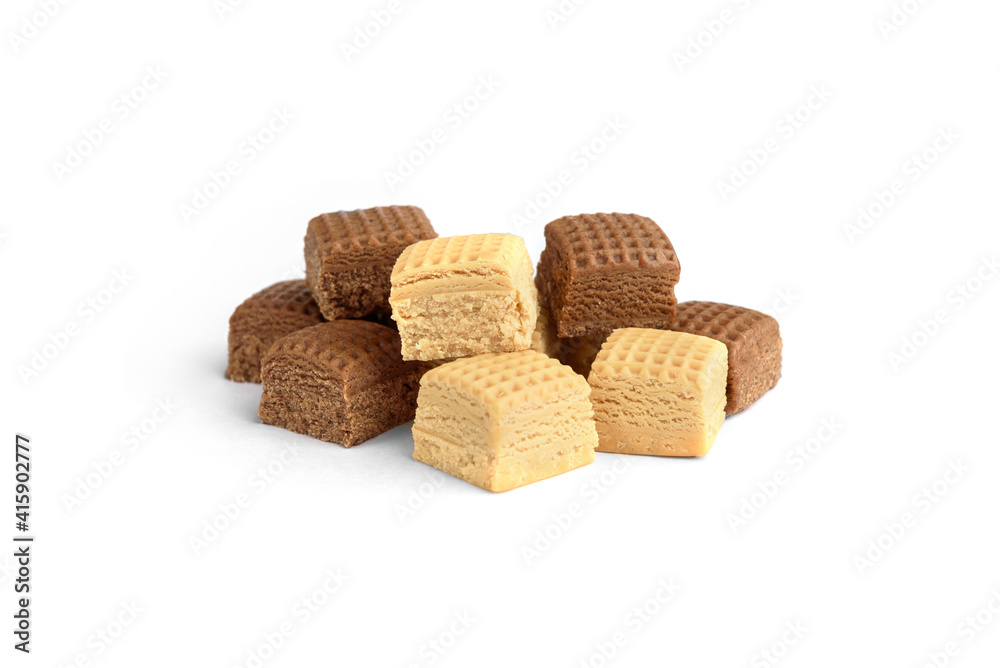Heap of chocolate and creamy toffee candy squares isolated on white background.