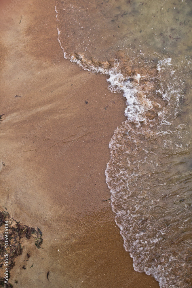 Sandy beach and waves. View from above.