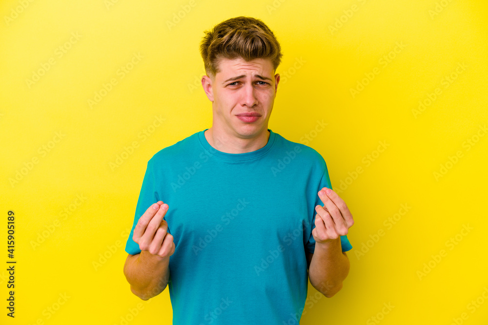 Young caucasian man isolated on yellow background showing that she has no money. Young caucasian man isolated on yellow background showing that she has no money.