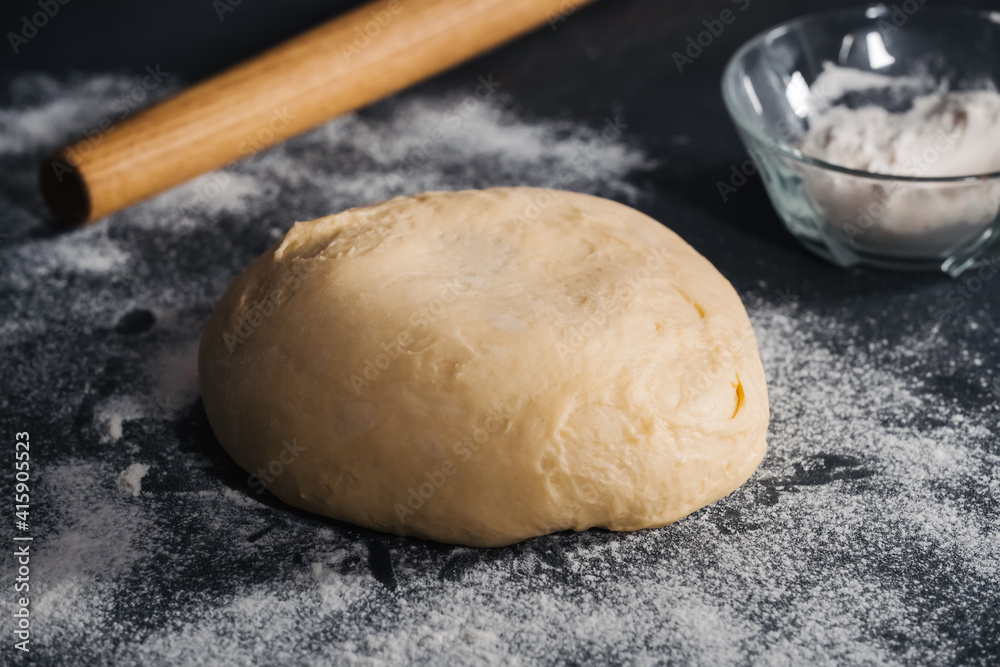 Handmade dough for bread on dark table background Handmade dough for bread on dark table background