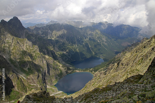 Fototapeta Naklejka Na Ścianę i Meble -  Mountain lakes of Czarny Staw pod Rysami and Morskie Oko seen from Poland's highest point, the north-western summit of Rysy, 2,499 metres (8,199 ft) in elevation.