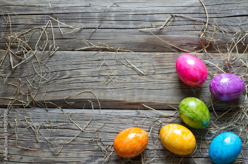 Photography Colorful easter eggs on old wooden boards background