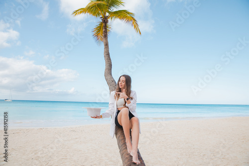 Palm tree Exotic nice girl in nature in a swimsuit