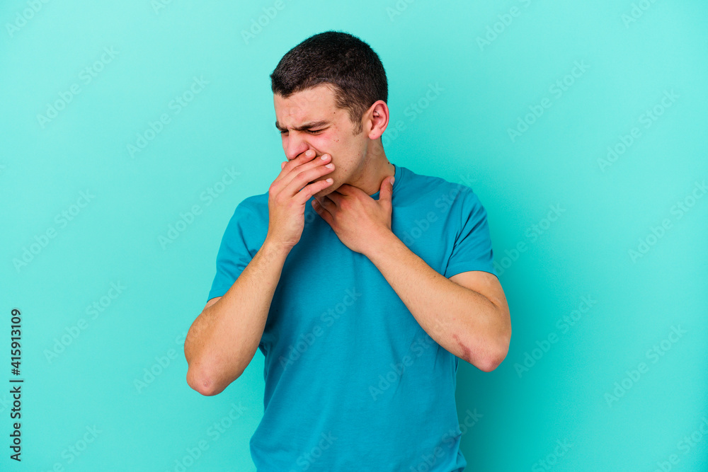 Young caucasian man isolated on blue background suffers pain in throat due a virus or infection. Young caucasian man isolated on blue background suffers pain in throat due a virus or infection.