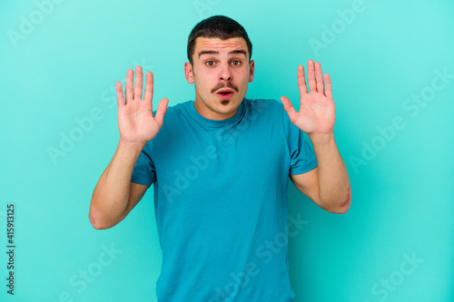 Young caucasian man isolated on blue background having an idea, inspiration concept.