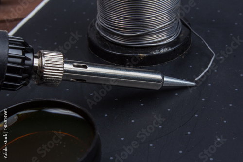 Soldering tools. Soldering iron, and solder, on a black background