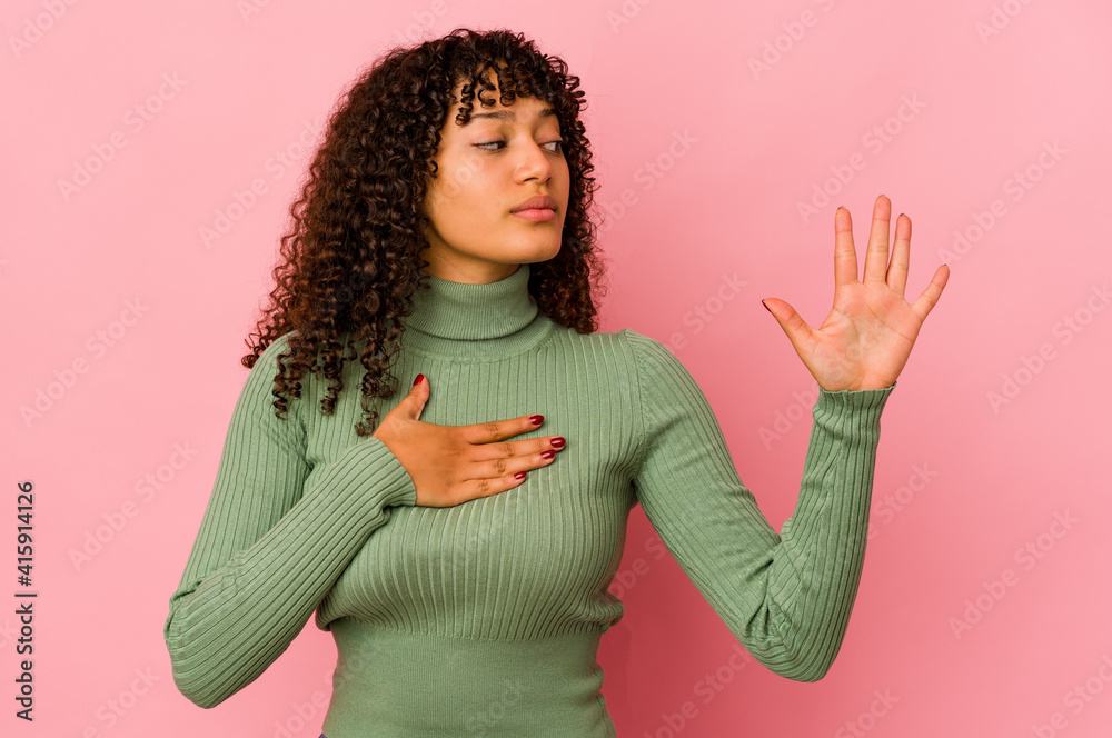 Young african american afro woman isolated taking an oath, putting hand on chest. Young african american afro woman isolated taking an oath, putting hand on chest.