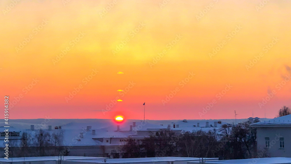 The sunset over the city and hills with orange sky. The sunset over the city and hills with orange sky.