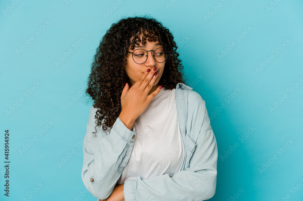 Young african american afro woman isolated yawning showing a tired gesture covering mouth with hand. Young african american afro woman isolated yawning showing a tired gesture covering mouth with hand.