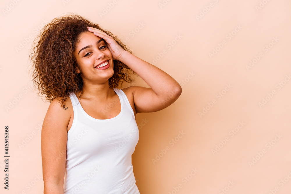 Young african american woman isolated on beige background laughing happy, carefree, natural emotion. Young african american woman isolated on beige background laughing happy, carefree, natural emotion.