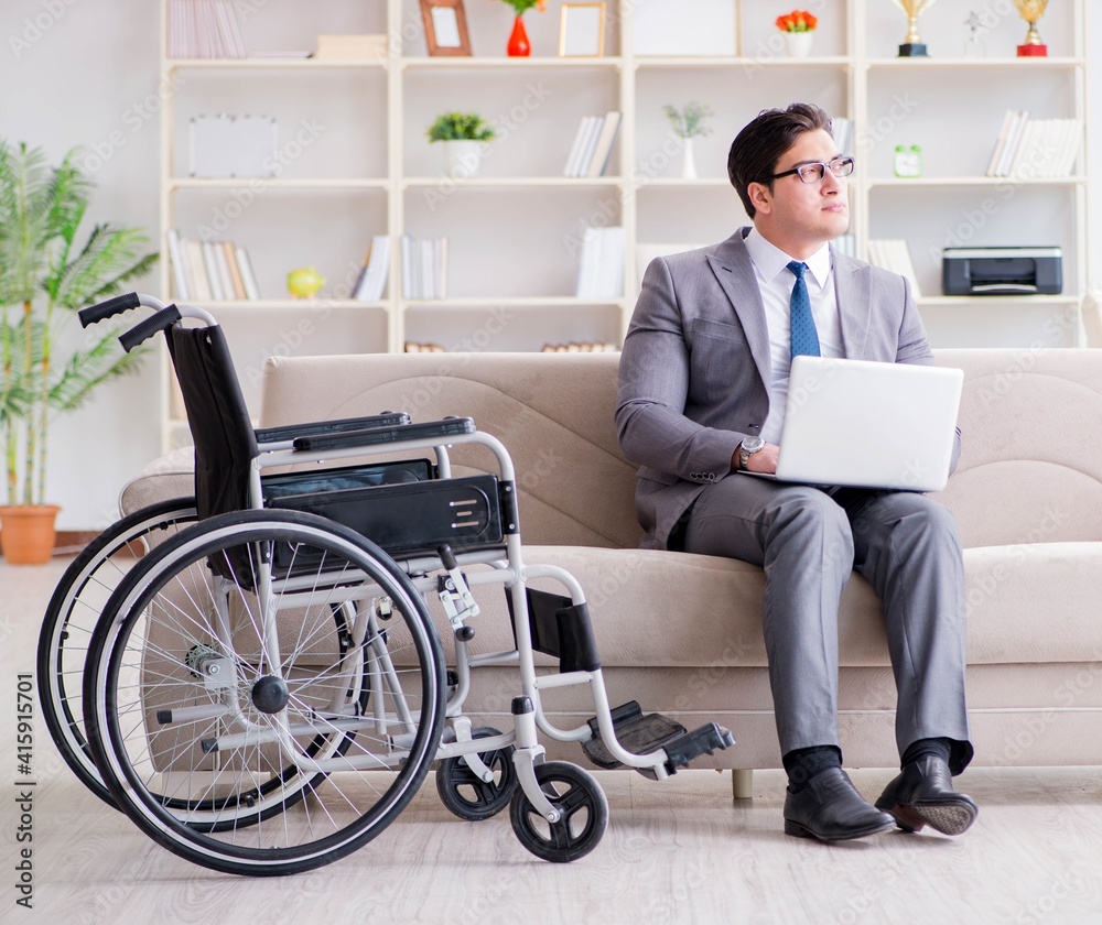 Dsabled businessman on wheelchair working home Dsabled businessman on wheelchair working home