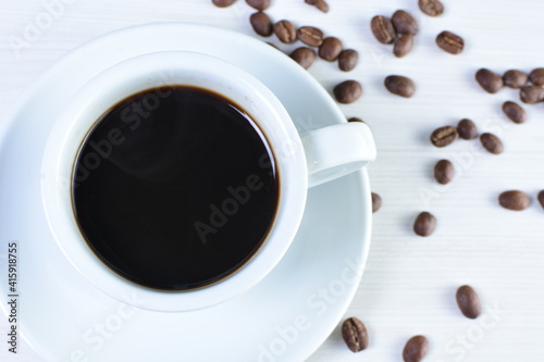 Cup of colombian coffee, decorated on white wooden background