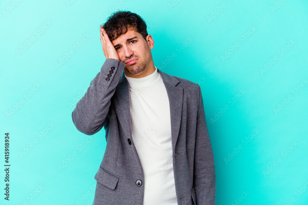Young caucasian man isolated on blue background tired and very sleepy keeping hand on head. Young caucasian man isolated on blue background tired and very sleepy keeping hand on head.