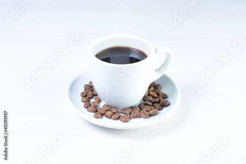 Cup of colombian coffee  decorated on white wooden background
