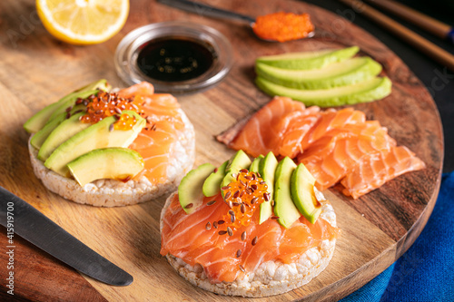 Puffed rice spread with raw salmon and avocado