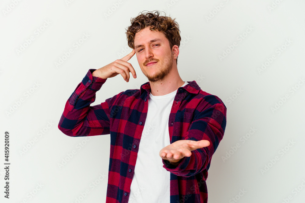 Young caucasian man isolated on white background holding and showing a product on hand. Young caucasian man isolated on white background holding and showing a product on hand.