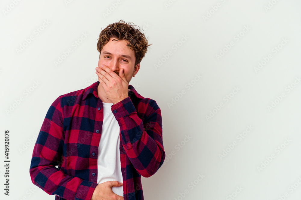 Young caucasian man isolated on white background laughing happy, carefree, natural emotion.